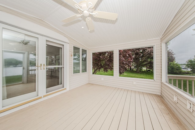unfurnished sunroom featuring a ceiling fan and vaulted ceiling