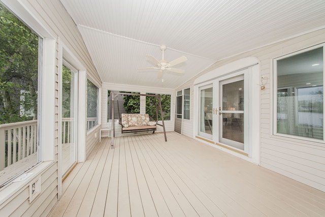 unfurnished sunroom featuring a ceiling fan and lofted ceiling