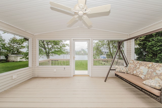 unfurnished sunroom with ceiling fan, lofted ceiling, and a water view