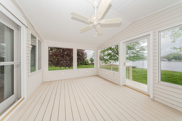 unfurnished sunroom featuring ceiling fan, a water view, and vaulted ceiling