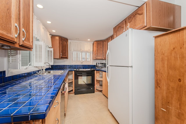 kitchen with appliances with stainless steel finishes, a sink, tile countertops, recessed lighting, and brown cabinets