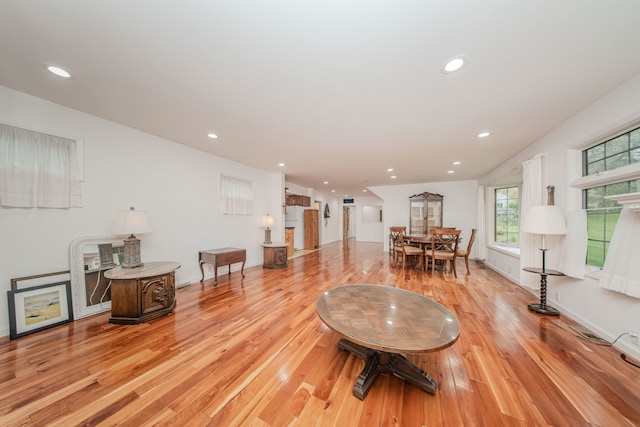 living area featuring light wood-type flooring and recessed lighting