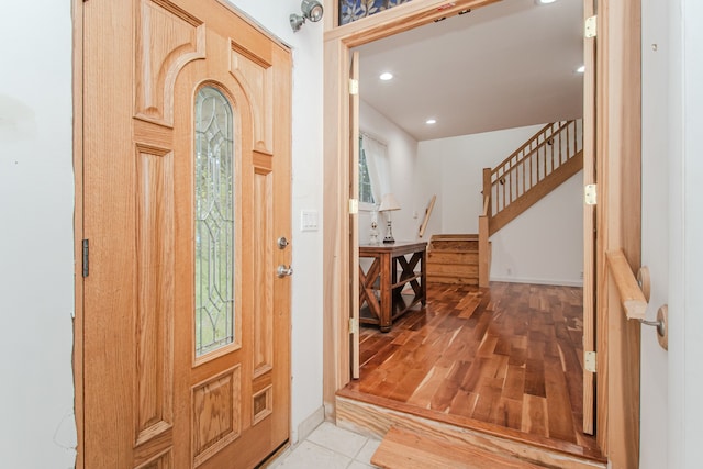 foyer entrance featuring stairs, recessed lighting, and light wood-style flooring