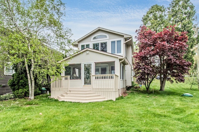 view of front facade with a sunroom and a front lawn