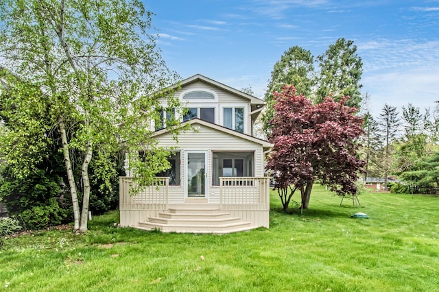 view of front facade with a front yard and a sunroom