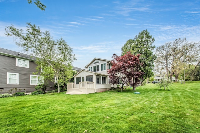 rear view of property with a yard