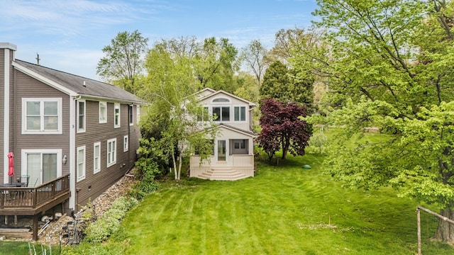 view of grassy yard with a deck