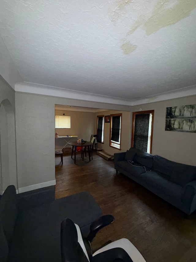 living room with wood finished floors, arched walkways, billiards, a textured ceiling, and baseboards