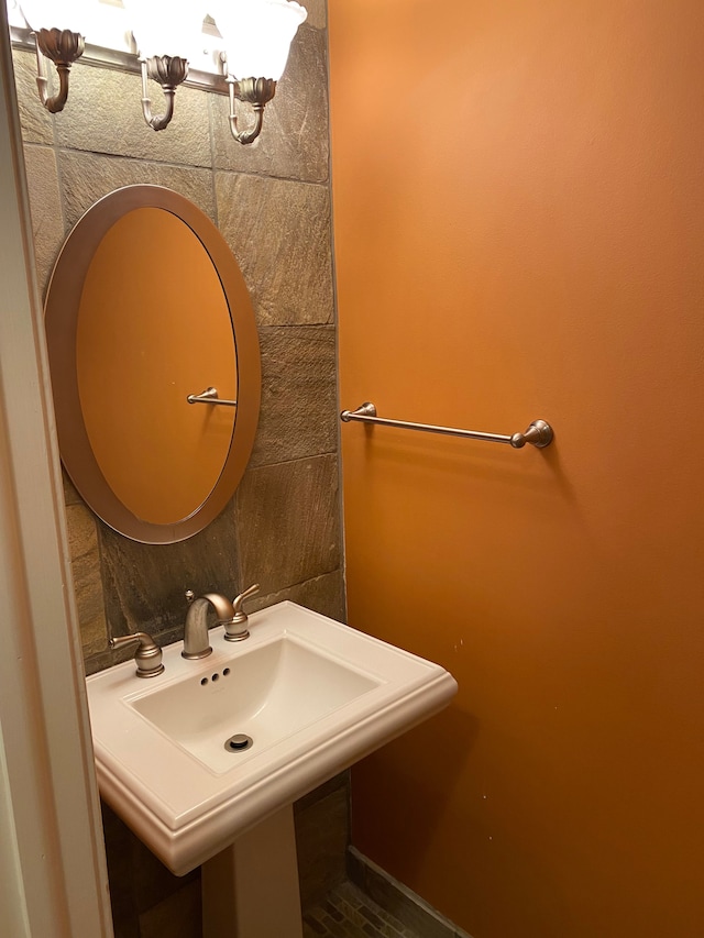 bathroom featuring a chandelier and a sink