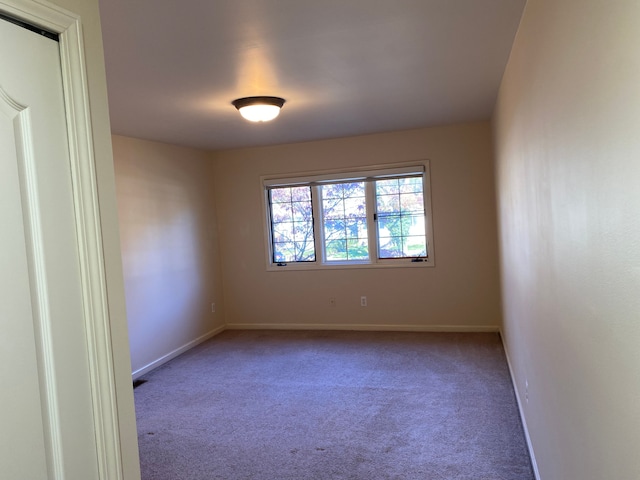 empty room with carpet flooring and baseboards