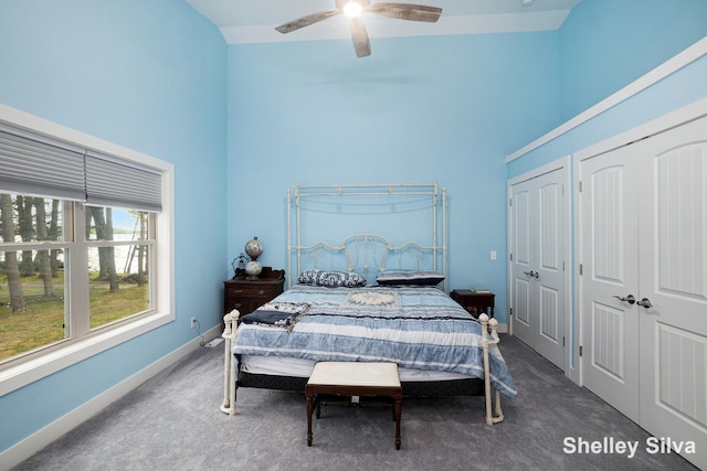 2496 Wolf Lake Dr, Baldwin, MI 49304 - bedroom with a high ceiling, carpet flooring, two closets, a ceiling fan, and baseboards