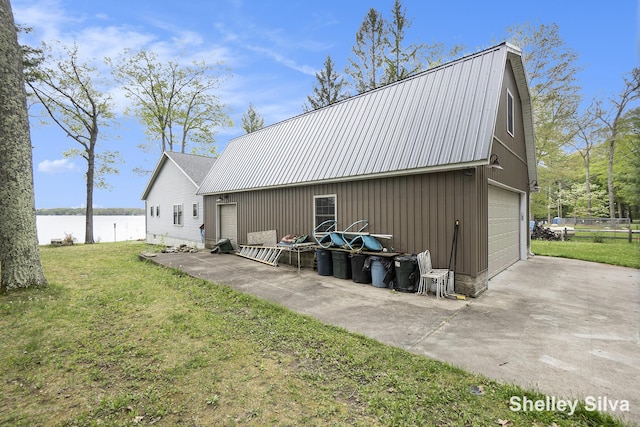 2496 Wolf Lake Dr, Baldwin, MI 49304 - view of outbuilding featuring a water view, driveway, and an outbuilding