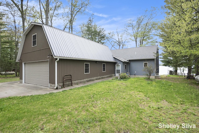 2496 Wolf Lake Dr, Baldwin, MI 49304 - view of front of home featuring a front lawn, metal roof, a gambrel roof, and a detached garage