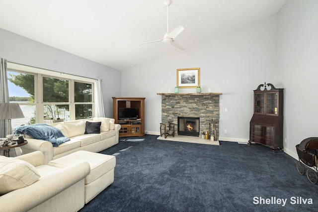2496 Wolf Lake Dr, Baldwin, MI 49304 - living area with dark colored carpet, a fireplace, ceiling fan, baseboards, and high vaulted ceiling