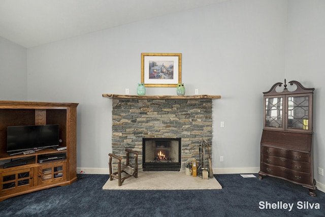 2496 Wolf Lake Dr, Baldwin, MI 49304 - living room with vaulted ceiling, carpet floors, a stone fireplace, and baseboards
