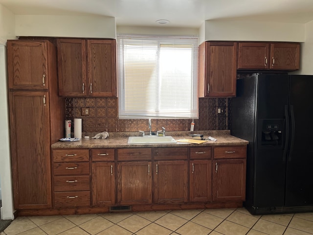 5606 Harold St, Hamtramck, MI 48212 - kitchen with black fridge with ice dispenser, a sink, tasteful backsplash, and light tile patterned floors