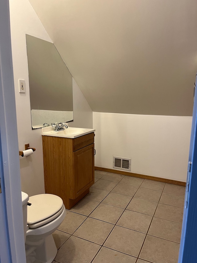 5606 Harold St, Hamtramck, MI 48212 - half bath with lofted ceiling, vanity, toilet, and tile patterned floors
