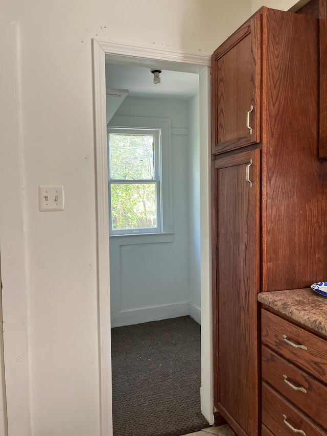 5606 Harold St, Hamtramck, MI 48212 - kitchen featuring carpet flooring, brown cabinetry, and baseboards