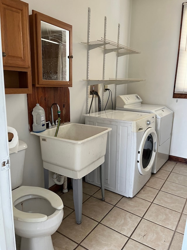 5606 Harold St, Hamtramck, MI 48212 - clothes washing area with washing machine and dryer and light tile patterned floors