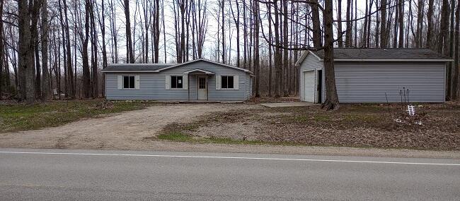 6483 Mancelona Rd, Mancelona, MI 49659 - single story home with an outdoor structure, driveway, and a garage