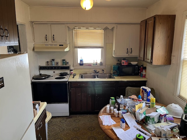 278 Oregon St, Ypsilanti, MI 48198 - kitchen with range with electric stovetop, under cabinet range hood, a sink, light countertops, and black microwave