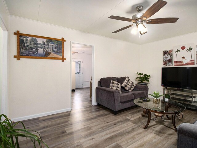 405 Jean St, Sturgis, MI 49091 - living area featuring wood finished floors, crown molding, a ceiling fan, and baseboards