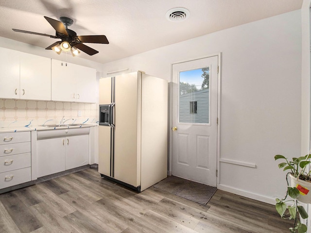 405 Jean St, Sturgis, MI 49091 - kitchen featuring white refrigerator with ice dispenser, white cabinetry, light countertops, and tasteful backsplash