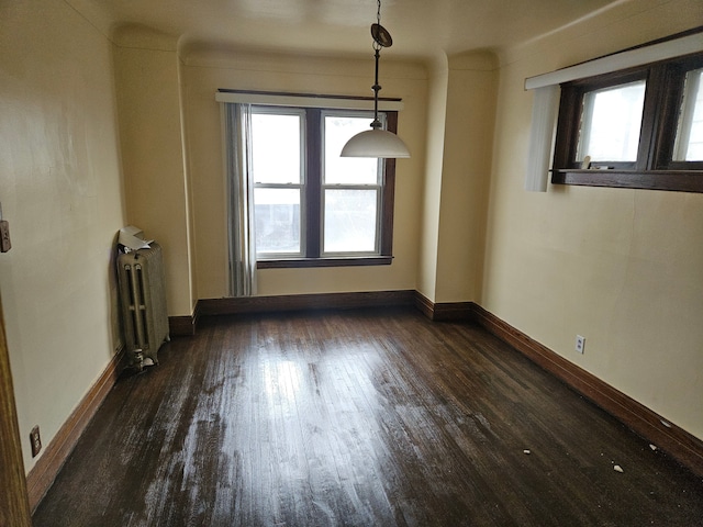 5297 Vancouver St, Detroit, MI 48204 - unfurnished dining area with radiator, plenty of natural light, dark wood-type flooring, and baseboards