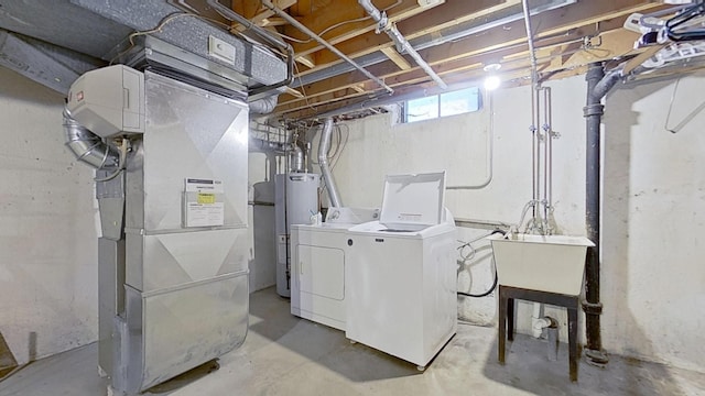 32259 Roy Dr, Warren, MI 48088 - clothes washing area with washing machine and dryer, water heater, and heating unit
