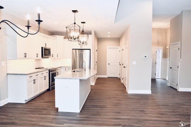 11140 S Custer Rd, Monroe, MI 48161 - kitchen featuring appliances with stainless steel finishes, white cabinets, decorative backsplash, light stone countertops, and recessed lighting