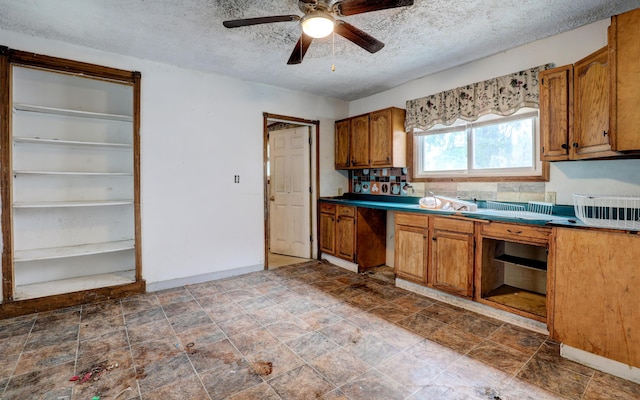 156 W 19th St, Holland, MI 49423 - kitchen with brown cabinetry, ceiling fan, a textured ceiling, backsplash, and baseboards