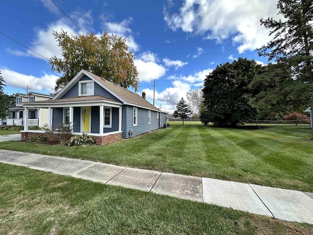 12061 Emelia St, Birch Run, MI 48415 - view of front of house with covered porch and a shingled roof