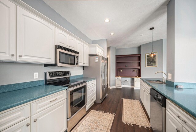 327 State St # 2, Saint Joseph, MI 49085 - kitchen with stainless steel appliances, a sink, dark wood-type flooring, white cabinetry, and dark countertops