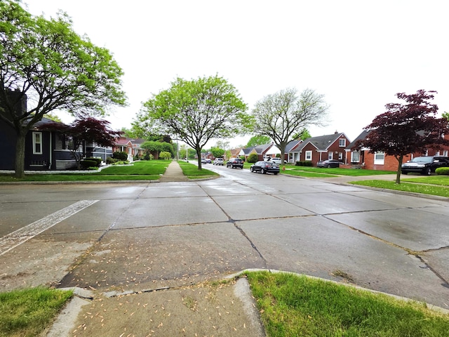 19266 Tyrone St, Harper Woods, MI 48225 - view of concrete street featuring a residential view, curbs, and sidewalks