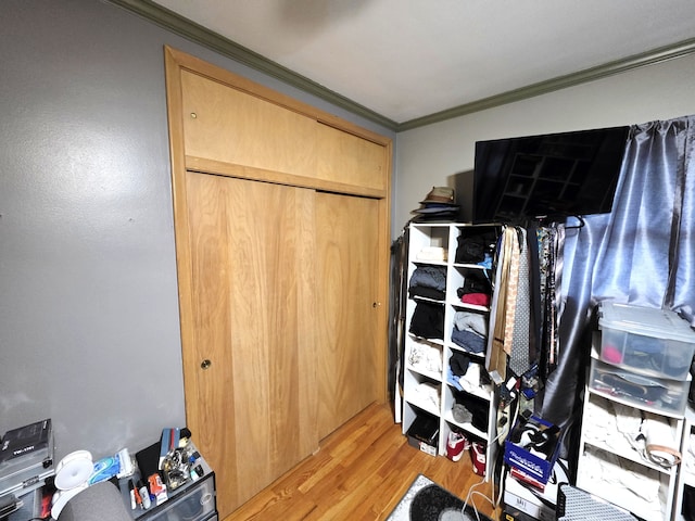 19266 Tyrone St, Harper Woods, MI 48225 - bedroom featuring crown molding, light wood-type flooring, and a closet