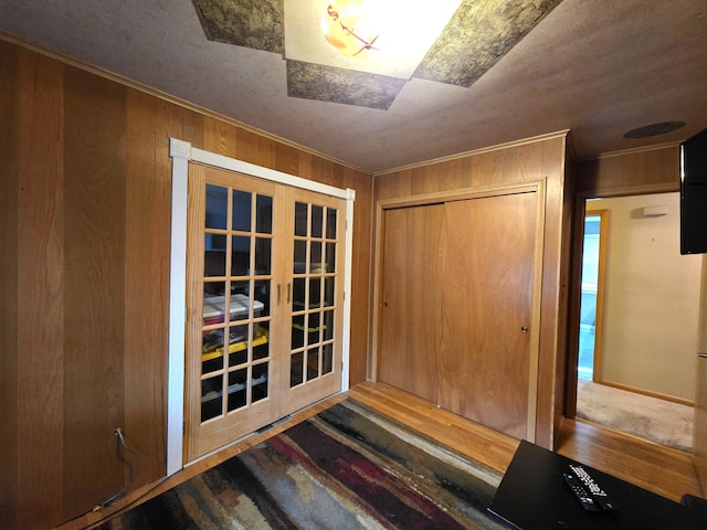 19266 Tyrone St, Harper Woods, MI 48225 - doorway to outside featuring french doors, wood finished floors, ornamental molding, and wood walls