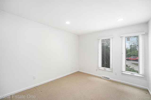 3079 Ravinewood Dr, Commerce Twp, MI 48382 - spare room with light colored carpet, baseboards, and recessed lighting