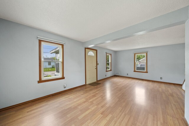 5732 Selfridge Blvd, Lansing, MI 48911 - empty room with light wood-style floors, a textured ceiling, and baseboards