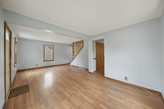 5732 Selfridge Blvd, Lansing, MI 48911 - empty room featuring stairway, light wood-style flooring, and baseboards