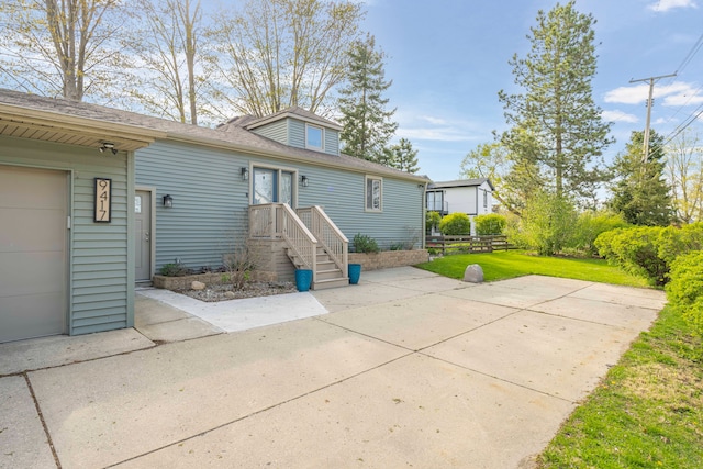 9417 Cedar Island Rd, White Lake, MI 48386 - rear view of property featuring a lawn, a garage, and a shingled roof