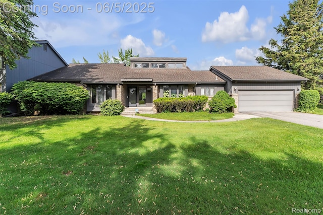 5520 Ridgewood, West Bloomfield, MI 48322 - view of front of house with a garage, driveway, a front lawn, and brick siding