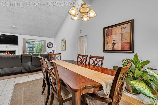 5520 Ridgewood, West Bloomfield, MI 48322 - tiled dining area featuring vaulted ceiling, a lit fireplace, a chandelier, and a textured ceiling