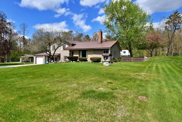 9609 E Madison Rd, Saint Helen, MI 48656 - view of front facade featuring a chimney, an attached garage, concrete driveway, a front yard, and metal roof