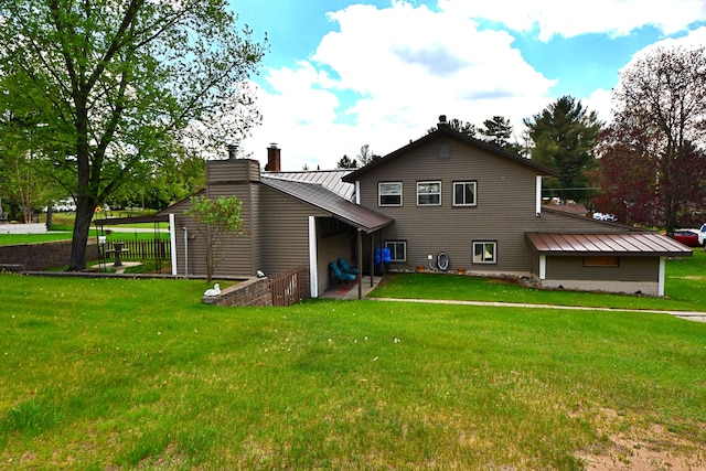9609 E Madison Rd, Saint Helen, MI 48656 - rear view of property featuring a chimney and a lawn