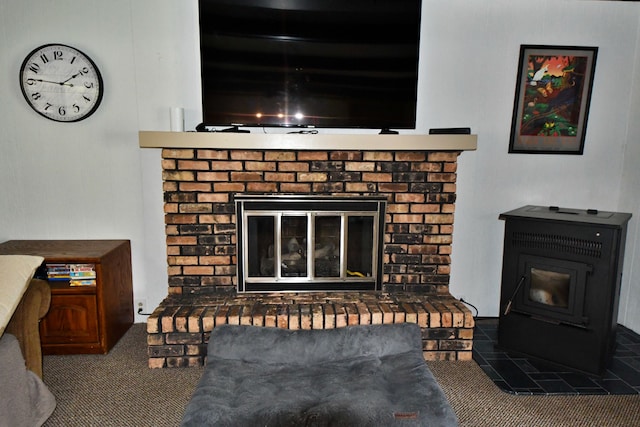9609 E Madison Rd, Saint Helen, MI 48656 - detailed view of a fireplace, a wood stove, and carpet floors