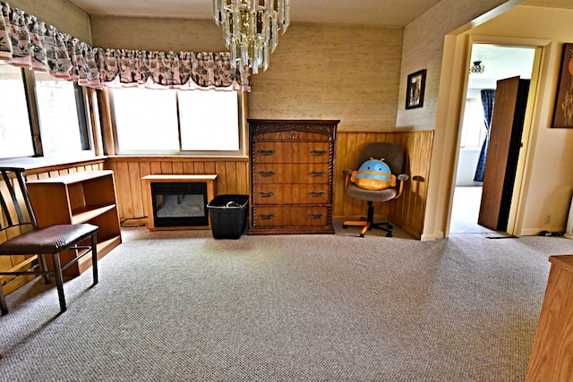 9609 E Madison Rd, Saint Helen, MI 48656 - sitting room featuring carpet, a glass covered fireplace, a chandelier, and baseboards