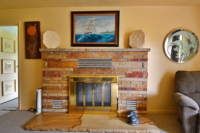 9609 E Madison Rd, Saint Helen, MI 48656 - detailed view of a stone fireplace, carpet flooring, and baseboards