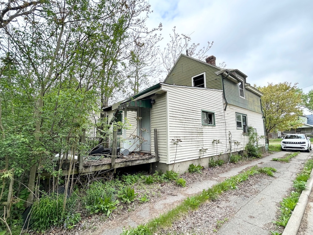 2535 Flushing Rd, Flint, MI 48504 - view of property exterior featuring a chimney and a deck