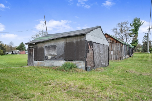 155 N Cook Ave, Harrison, MI 48625 - view of side of property with a lawn, a barn, and an outdoor structure