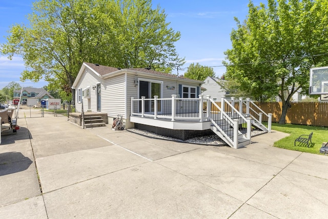 22171 Monterey Dr, Trenton, MI 48183 - rear view of house with fence, a deck, and a patio